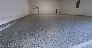 Finished flake epoxy garage floor with a glossy polyaspartic top coat in a residential garage