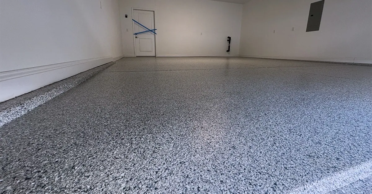 Finished flake epoxy garage floor with a glossy polyaspartic top coat in a residential garage